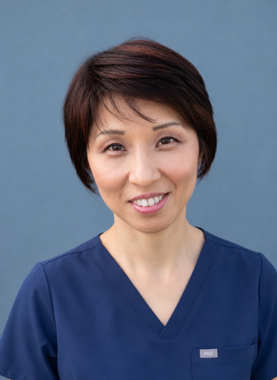 Friendly portrait of Shizue Hayashi Ito in navy clinical scrubs